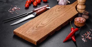An empty plate with a knife, fork or spoon with a wooden cutting board photo