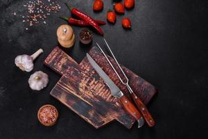 An empty plate with a knife, fork or spoon with a wooden cutting board photo