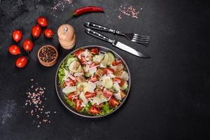 Delicious spring fresh vegetable salad with cherry tomatoes, cucumber, breadcrumbs and parmesan cheese photo