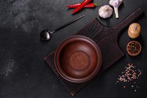 An empty plate with a knife, fork or spoon with a wooden cutting board photo