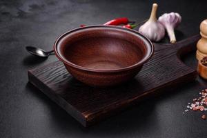 An empty plate with a knife, fork or spoon with a wooden cutting board photo