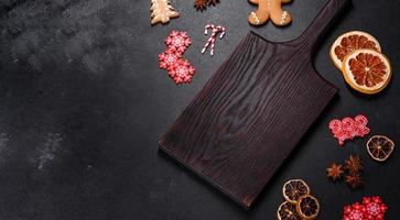 Christmas table setting with empty black ceramic plate, fir tree and black accessories photo