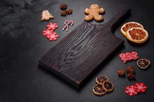 Christmas table setting with empty black ceramic plate, fir tree and black accessories photo