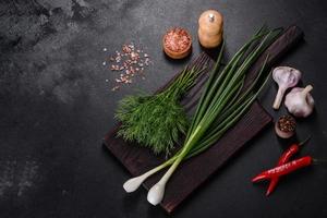 Spring onions, dill, garlic and hot pepper as well as spices and herbs photo
