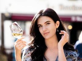 A beautiful Ukrainian girl  drinks wine photo