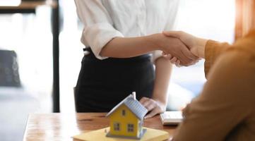 Real estate agents and customers shake hands to congratulate on signing a contract to buy a house with land and insurance, handshake and Good response concept. photo