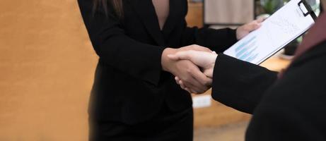 businesswomen Handshaking,happy with work,the woman she is enjoying with her workmate,Handshake Gesturing People Connection Deal Concept photo