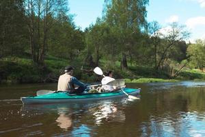 Family kayak trip. An elderly married couple rowing a boat on the river, a water hike, a summer adventure. Age-related sports, mental youth and health, tourism, active old age photo