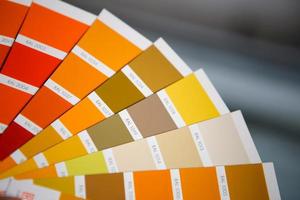 Selection of the paint color for decorative home repairs to the palette with layouts. A fan of shades in your hand inside the home. Repair and construction, paint and varnish coating photo