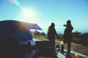 Lover woman and man asians travel relax camping in the holiday. On the Moutain. Watch the sun rise. Thailand photo