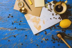 accessories for the traveler on the old background on the on blue wood table. Travel concept using world map and compass along with other travel accessories. summer photo