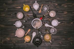 Many cups of coffee with beans on wooden table, top view. Flat lay composition with cups of coffee on background Old wood grain. Food photography, beverage. photo