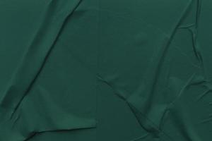 Blank green paper is crumpled texture background. Crumpled paper texture backgrounds for various purposes photo