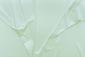 Blank green paper is crumpled texture background. Crumpled paper texture backgrounds for various purposes photo