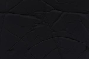 Blank black paper is crumpled texture background. Crumpled paper texture backgrounds for various purposes photo