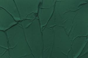 Blank green paper is crumpled texture background. Crumpled paper texture backgrounds for various purposes photo