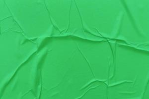 Blank green paper is crumpled texture background. Crumpled paper texture backgrounds for various purposes photo