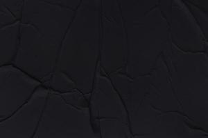 Blank black paper is crumpled texture background. Crumpled paper texture backgrounds for various purposes photo