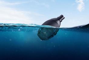 plastic bottle and bomb effect thrown into the sea photo