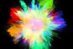 Colorful powder explosion, isolated on black background photo