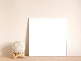 Modern and minimalist square white poster or photo frame mockup on the living room wooden table. 3d rendering.