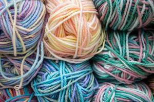 Many balls of wool yarn for knitting. Selling fluffy threads in a craft store photo