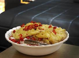 delicious quick meal local thai style deep fried omelette with load of red chilli photo