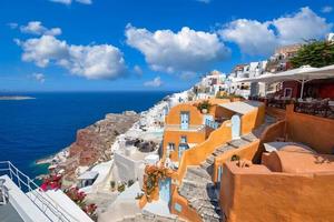 Santorini island, Greece as travel landscape background. Beautiful romantic white architecture, pink flowers and sea view. Summer vacation, couple holiday destination. Amazing traveling scenic photo