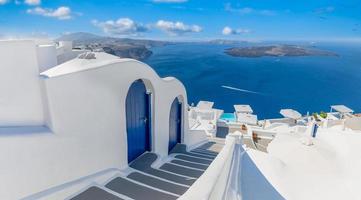 Dream vacation in Santorini Greece. Stairs into blue calm sea bay with cliffs and volcano. White architecture blue doors, fantastic romantic cityscape. Amazing travel, fantastic scenic view photo