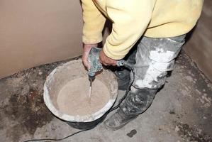 plasterer with an electric drill photo