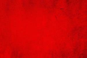 Red matte background of suede. Velvet texture of seamless leather. Red suede texture. photo