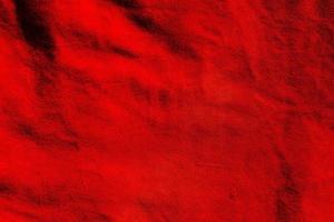 Red matte background of suede. Velvet texture of seamless leather. Red suede texture. photo