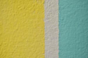 A yellow and blue wall painted with stripes and a triangle photo