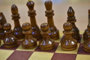 Chessboard with wooden pieces black and white photo