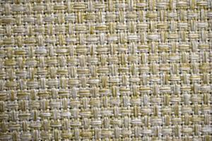 Yellow carpet fabric background close-up with threads photo
