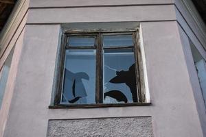 The walls of yellow old classic houses. Broken windows. photo