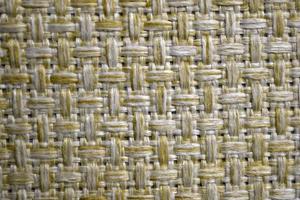 Yellow carpet fabric background close-up with threads photo