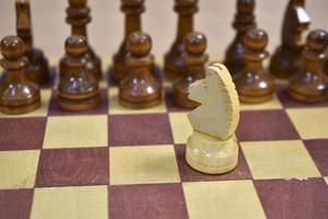 Chessboard with wooden pieces black and white photo