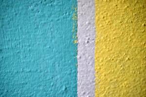 A yellow and blue wall painted with stripes and a triangle photo