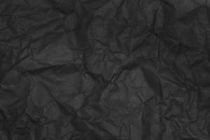 black crumpled paper texture as background photo