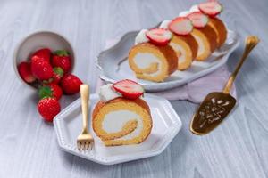Strawberry swiss roll cake with whipped cream photo