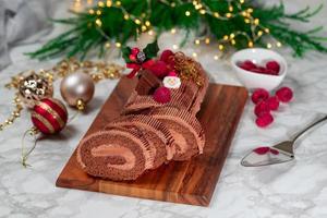 Traditional Christmas cake, chocolate Yule log with festive decorations photo