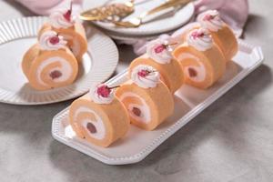Cherry blossom flavored roll cake or swiss roll with whipped cream and cherry blossoms bean jam photo