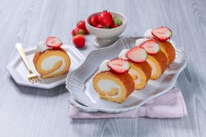 Strawberry swiss roll cake with whipped cream photo