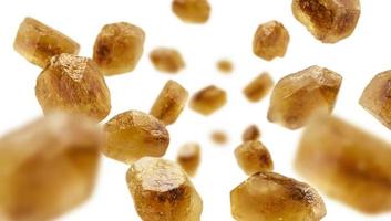 Caramelized sugar levitates on a white background photo