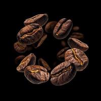 los granos de café levitan sobre un fondo negro foto