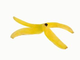 One banana peel, golden yellow, which is eaten until the end, leaving only the peel turned into solid waste. Shot in the studio on a white background with clipping paths and copy space isolated. photo