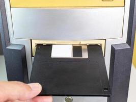 Hold the Floppy A disc and insert the reader. to read and write data It's technology old that have been used for a long time The disc will be less. has a square shape Must press a button to remove photo