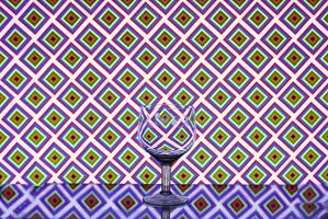 Glass wine glass on a background of squares photo