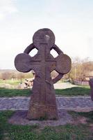 old stone cross on the grave photo